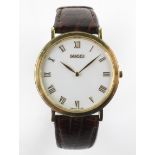 A Gucci cased gentleman's wristwatch, with brown leather strap, white dial with gilt metal case,