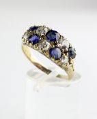 A yellow metal, diamond and sapphire cluster ring, with two rows of five stones,