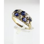 A yellow metal, diamond and sapphire cluster ring, with two rows of five stones,