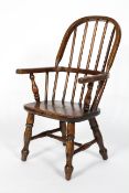 A Child's elm Windsor chair, on turned baluster splayed legs,