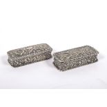 Two silver snuff boxes, of rectangular form, embossed overall with scrolls within frilled rims,