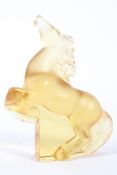 A Lalique frosted amber rearing Kazak horse, etched Lalique/France mark, on a clear plinth base,