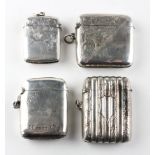 A selection of four silver vesta cases, including an example of ribbed cylindrical form,