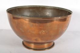 A large footed copper bowl, late 19th/early 20th century, on raised foot with turnover foot rim,