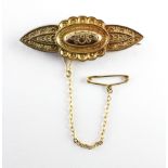 A yellow metal bar brooch with beaded filigree design.