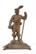 A cast iron Highlander doorstop, late 19th/early 20th century, cast standing on a mound,
