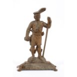 A cast iron Highlander doorstop, late 19th/early 20th century, cast standing on a mound,