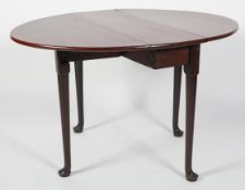 A George II style mahogany oval gate leg dining table, on tapering legs with pad feet,