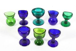 A collection of glass eye baths, mostly 19th/early 20th century,