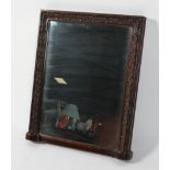 A mahogany overmantel mirror, the rectangular plate inside a carved frame,