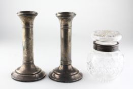 A pair of silver candlesticks, hallmarks rubbed, together with a silver mounted cut glass jar,