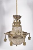 A gilt metal and cut glass chandelier, the bag beneath six lights,