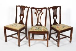 A pair of George III mahogany dining chairs, with pierced splats and drop in seats,