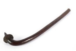 An African Zulu knobkerrie, with carved pointed tip and spikey seeded knop,