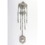 A late Victorian silver Chatelaine with pierced and scrolling foliate motifs, hung with five chains,