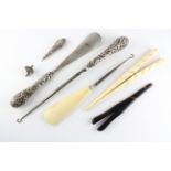 An assortment of silver handled items, to include a shoe horn/knitting hook, another shoehorn,