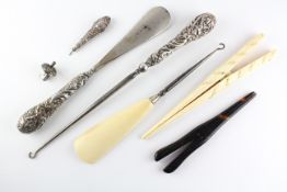 An assortment of silver handled items, to include a shoe horn/knitting hook, another shoehorn,