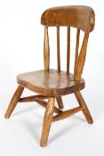 A Child's elm kitchen chair, with spindle back, on splayed legs,