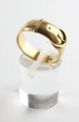 A yellow metal buckle ring. Hallmark has worn - testing indicates 18ct gold. Size O