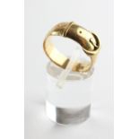 A yellow metal buckle ring. Hallmark has worn - testing indicates 18ct gold. Size O