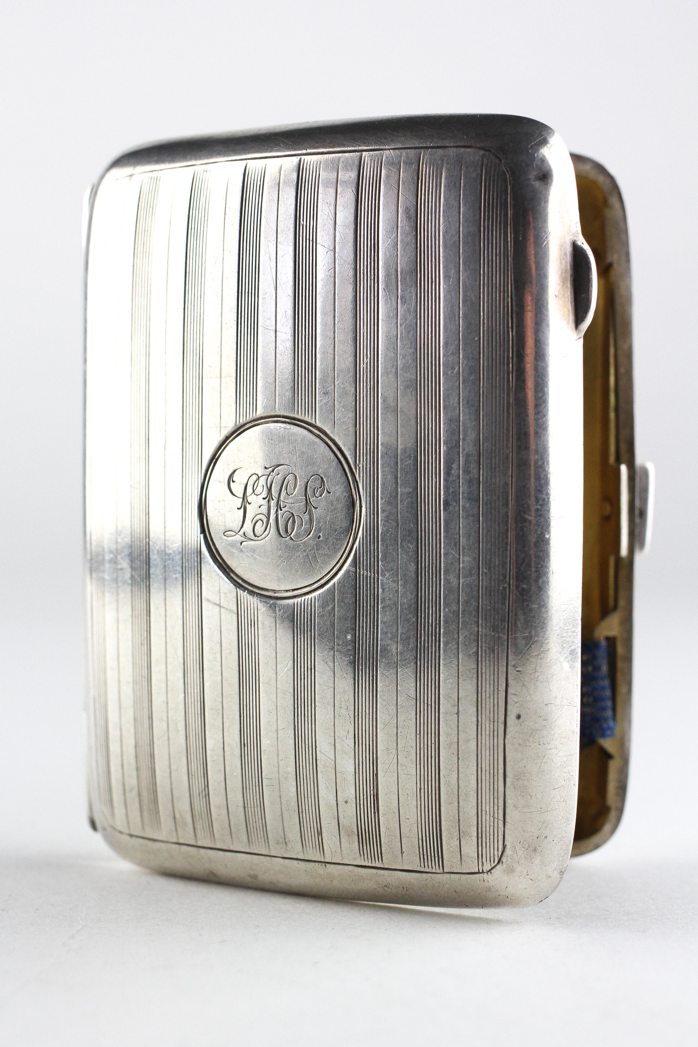 A George V silver cigarette case of rectangular form, hallmarked Birmingham 1918 by John Rose,