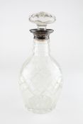 A George V silver topped cut-glass decanter and stopper, dated 1928,