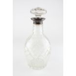 A George V silver topped cut-glass decanter and stopper, dated 1928,