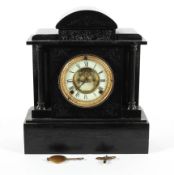 A Victorian black slate mantel clock, the ivorine dial with a central exposed escapement,