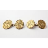 A yellow metal pair of chain link cufflinks with foliate engraved finish.
