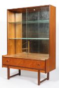 A 1960's Turnidge teak wood mirror backed glass display cabinet having twin glazed sliding doors