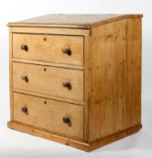 A pine clerks or architects desk, the hinged slope above with three large drawers, 105cm high,