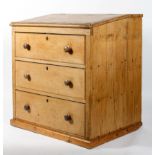 A pine clerks or architects desk, the hinged slope above with three large drawers, 105cm high,