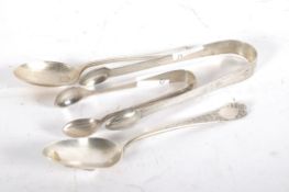 Two pairs of sugar tongs, one being Georgian with bright cut decoration,