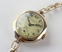 A yellow metal wristwatch.