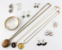 A collection of costume jewellery to include; A rolled gold bangle, Three pendant and chains,