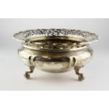 A large early 20th century silver bowl, raised upon three scrolling feet,