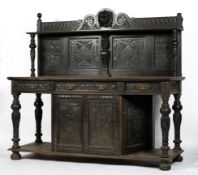 A 19th century oak buffet, the scrolling gallery above a single shelf and four carved panels,