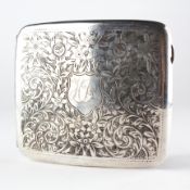 A George V silver cigarette case adorned with highly detailed floral engraved sprays,