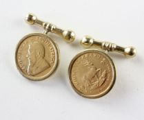 A yellow metal pair of cufflinks with Tbar and chain attachment,