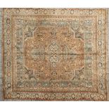 A machine made carpet to a Persian design, depicting hunting scenes in tones of cream and beige,