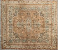 A machine made carpet to a Persian design, depicting hunting scenes in tones of cream and beige,