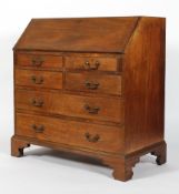 A George III-style mahogany bureau, the fall front enclosing a cupboard, drawers and pigeonholes,