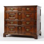 A 17th century oak two-section chest of drawers, with geometric panelled front,