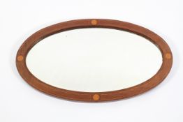 An Edwardian mahogany and boxwood inlaid oval mirror,