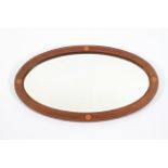 An Edwardian mahogany and boxwood inlaid oval mirror,