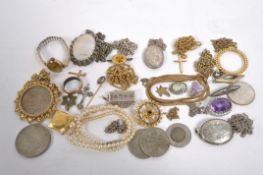 A large collection of jewellery to include brooches, necklaces, pendants with chains, two watches,