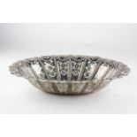 A late Victorian silver basket of oval form, decorated throughout with pierced and embossed motifs,