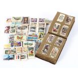 A collection of vintage Player's Cigarette cards, some mounted in an antique leather album,