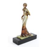An Art Deco style sculpture of a lady, on green onyx and black slate base,