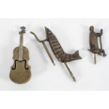 Three novelty brass locks, in the form of a cello, crayfish and monkey,